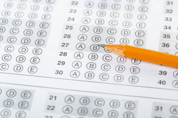 istock testing in exercise and exam paper. computer sheet with pencil in school test room, education concept 1307907078