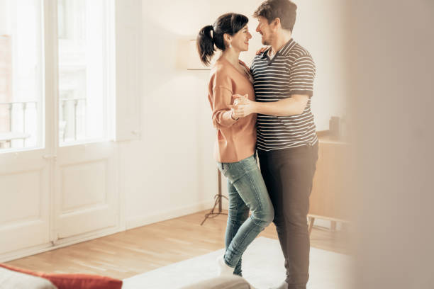 istock Couple dancing at home 1307907423