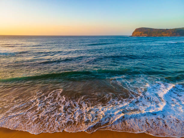 istock Aerial sunrise seascape with hazy blue sky 1307907440