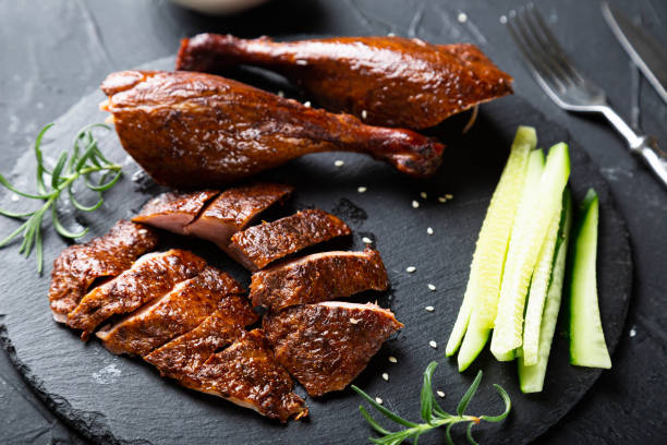 Peking duck with sauce on a dark table Peking duck with sauce on a dark table duck meat stock pictures, royalty-free photos & images