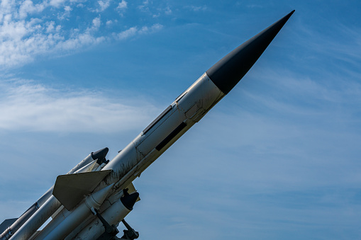 Detailed close up of an old English missile or rocket (RB68) nick named Bloodhound. On its launch ramp against a blue sky and brightly lit by the sun