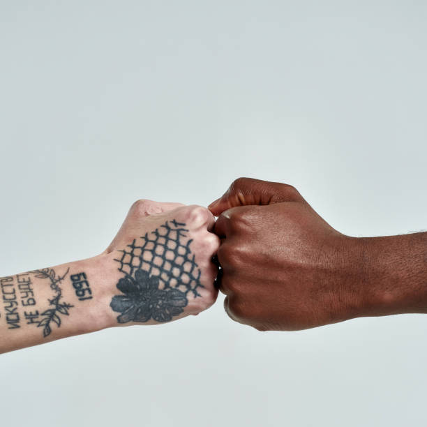 istock Multiracial people putting their fists together 1307911444