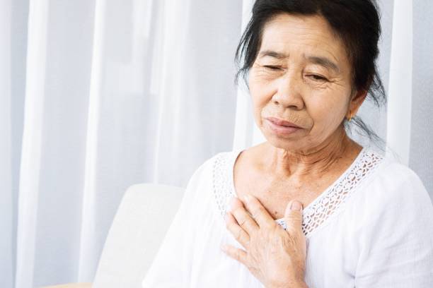 istock old Asian woman having problem with shortness of breath, difficult breathing 1307914852