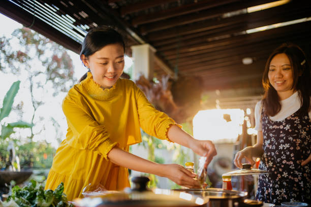 istock Young asian woman preparing soup for hot pot dinner 1307915116