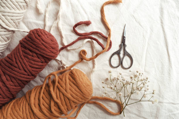 istock Small beautiful scissors in focus.Knitting yarn balls in different colors. 1307916180