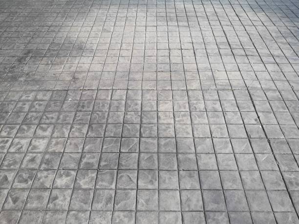 istock Stamp concrete black grey color hardener printing patterns on the cement or mortar surface block shape Square pattern material rough texture background 1307916419