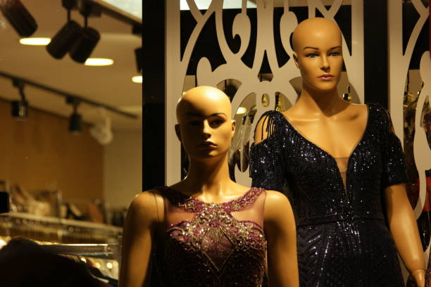 Female mannequins wearing sparkly evening dress. Female mannequins wearing sparkly evening dress. Stylish evening dresses on female mannequins. Woman's fashion for special occasion. red evening gown mannequin indoors stock pictures, royalty-free photos & images