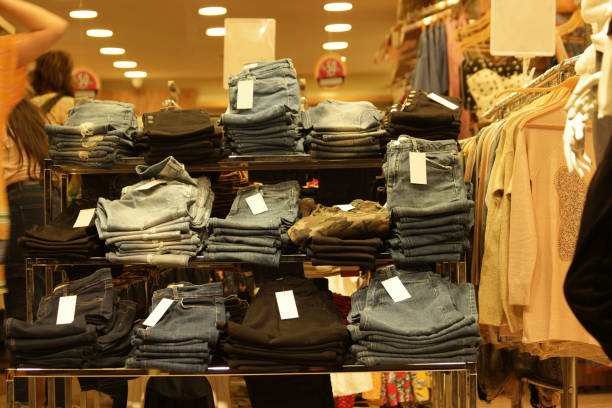 istock Jeans are stacked in piles at market stall. 1307920002