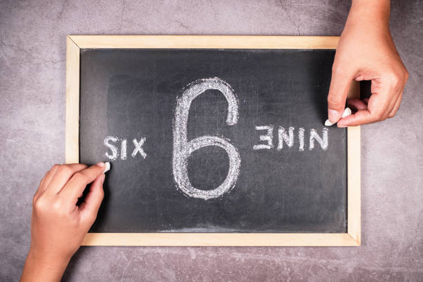 6 and 9 perspectives Hand writing from the point of view of 6 and 9 number on chalkboard in opposite direction, argument in different perspectives concept contrasts stock pictures, royalty-free photos & images