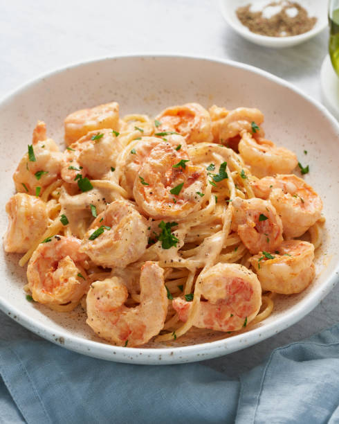 istock Pasta spaghetti with grilled shrimps sauce. Spaghetti with seafood. Macro side view, vertical 1307922533