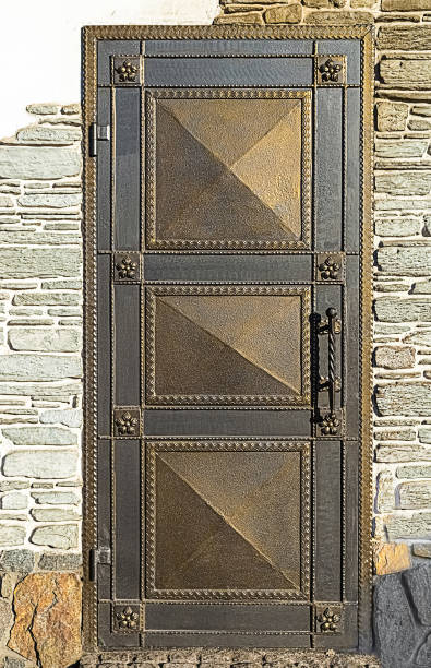 Forged door with flower elements in brick wall.