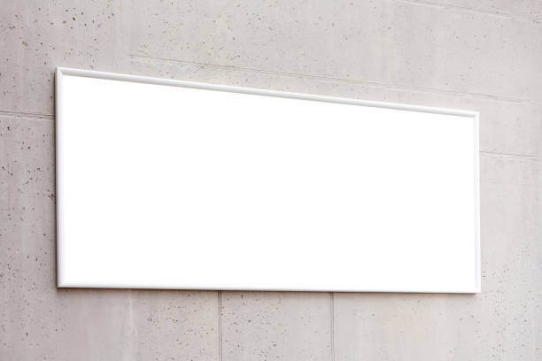 istock White blank horzontal poster frame, empty banner advertisement on a grey concrete wall inside the building, space for your text closeup Corporate business interior rectangle picture advert copy space 1307924423