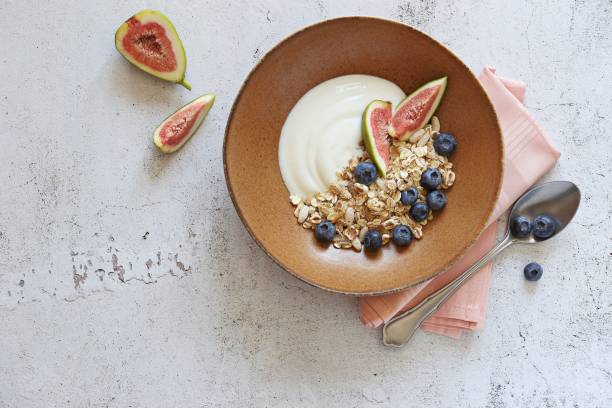 istock Muesli cereal mix with yogurt, fig and blueberries. 1307925452