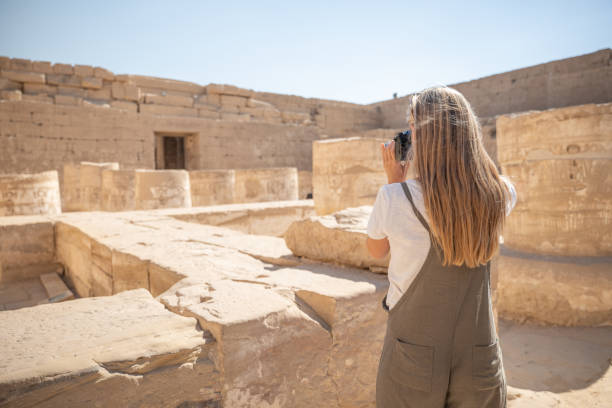 istock Woman traveling in Egypt takes photos with her camera 1307926708