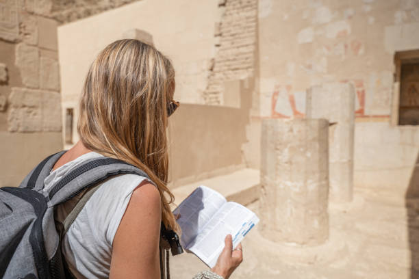 istock Woman discovers ancient temple with a guidebook 1307926715
