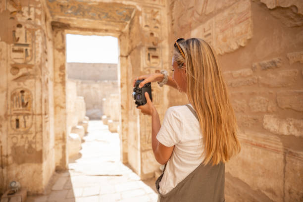 Travel blogger documents her trip in Egypt View of a female tourist enjoying a tour of Luxor sights, Egypt extraordinary place photographer stock pictures, royalty-free photos & images