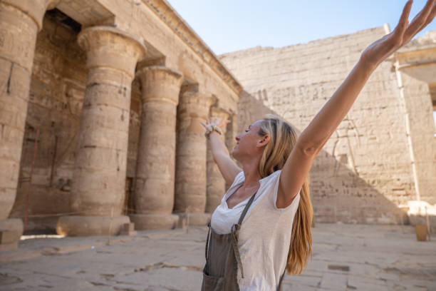 istock Grateful woman open arms up inside temple 1307926747