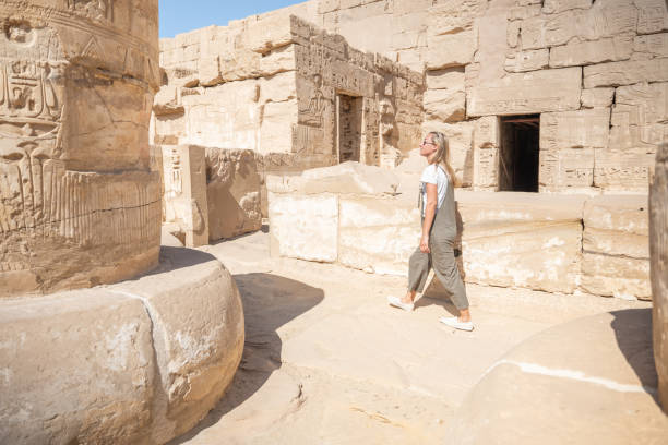istock Woman explores a temple in Luxor 1307926755