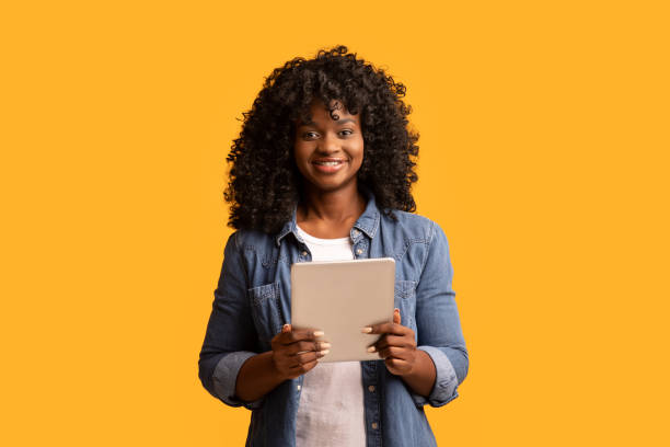 istock Happy beautiful black woman using modern digital tablet 1307927743