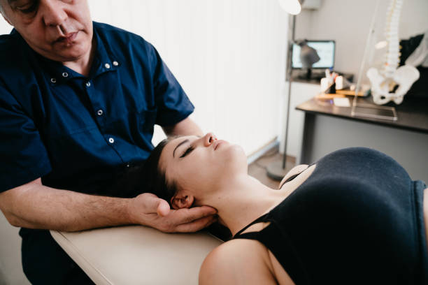 istock Physiotherapist practicing chiropractic techniques on a young adult woman patient 1307928158