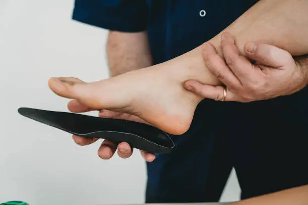 Photo of Young woman's foot on orthopedic insoles for medical foot correction