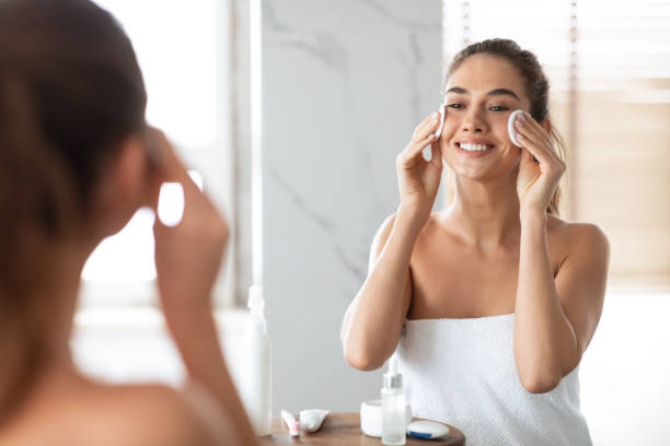 istock Woman Using Cotton Pads Cleansing Face Skin Standing In Bathroom 1307929237