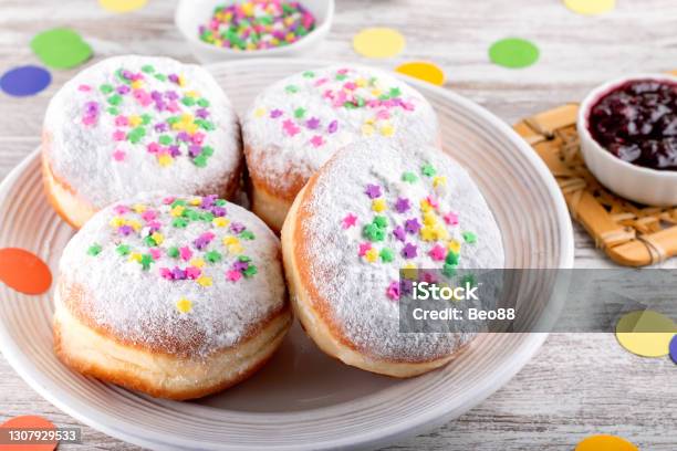 Carnival Sprinkled Doughnuts And Confetti Holiday Celebration Baking Top View Stock Photo - Download Image Now