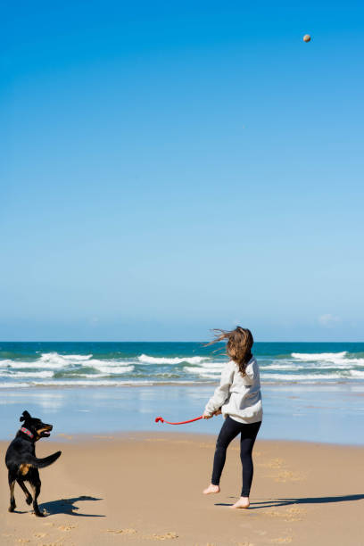 istock cute young girl on vacation with her dog 1307930843