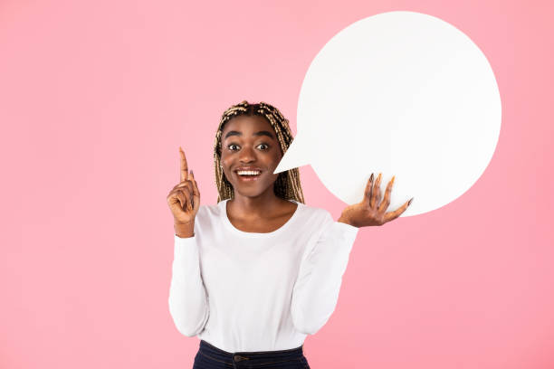 istock Excited black woman pointing finger up hoding speech bubble 1307931832
