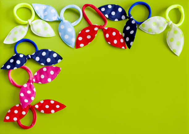 colorful elastic bands for hair on a green background