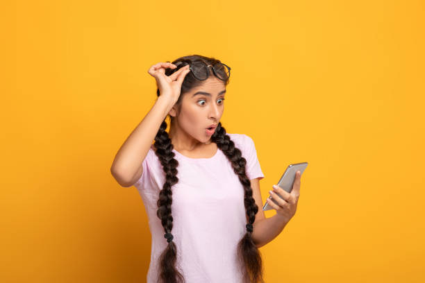 Excited indian woman using cellphone, celebrating online win