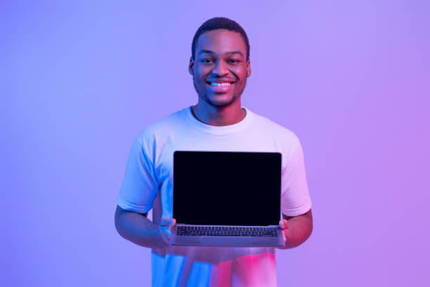 istock New Website. Happy African American Man Holding Laptop Computer With Black Screen 1307934448