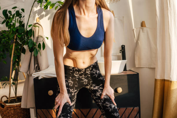 istock Portrait of unrecognizable woman doing abdominal vacuum. 1307934592