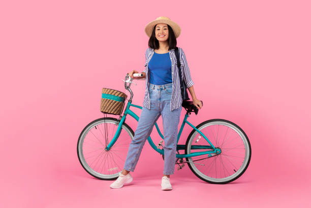 istock Asian woman standing with retro bicycle with wicker basket 1307934794