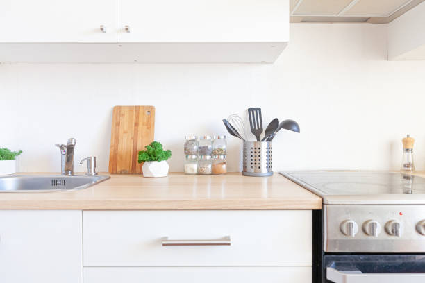 istock Scandinavian classic minimalistic kitchen with white and wooden details. Modern white kitchen clean contemporary style interior design 1307934981