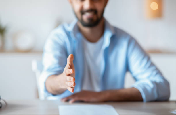istock Partnership Concept. Friendly Young Businessman Giving Hand For Handshake At Camera, Cropped 1307935727