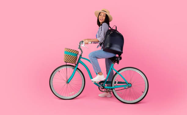 istock Asian lady riding retro bicycle with wicker basket 1307935756