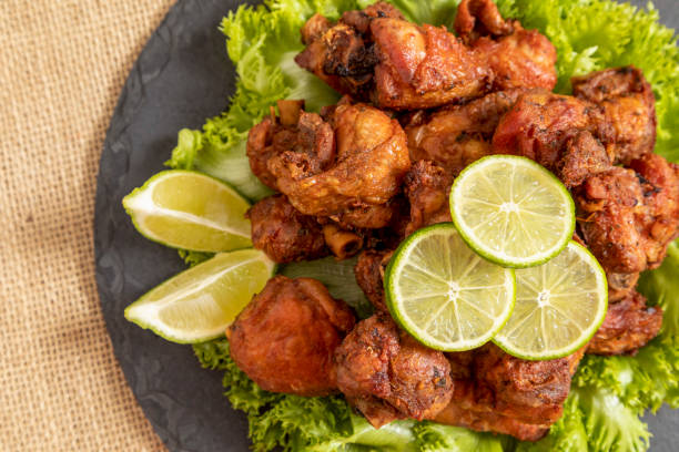 istock Portion of fried chicken on black stone plate 1307937075