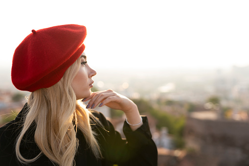 Portrait of a woman in a red beret. a woman in the city