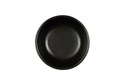 Small black bowl isolated on white background, Top view. The bowl is a kitchen utensil for holding food.