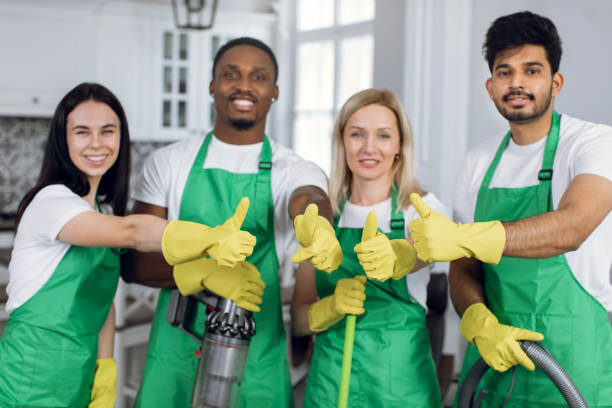 istock Smiling multiracial cleaners showing thumbs up 1307937802