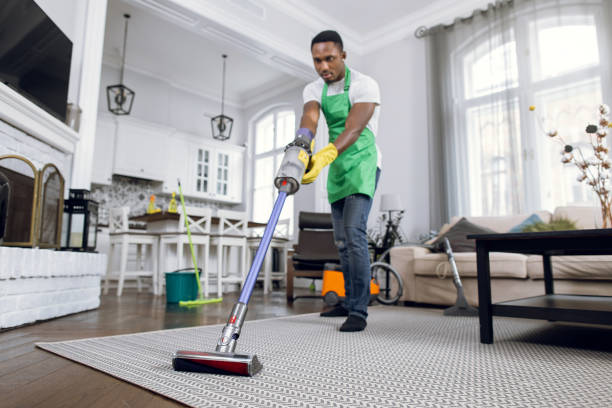 istock African man removing dust from carpet with vacuum cleaner 1307939113