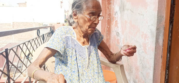 istock old woman cleaning the red greens , 1307940236