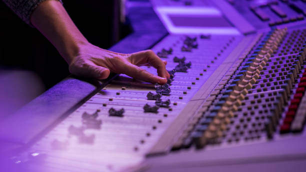 istock Close-up of male hand controlling faders on mixing panel 1307941718