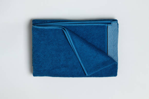 istock Close-up top view of folded blue towel on gray background. 1307942734