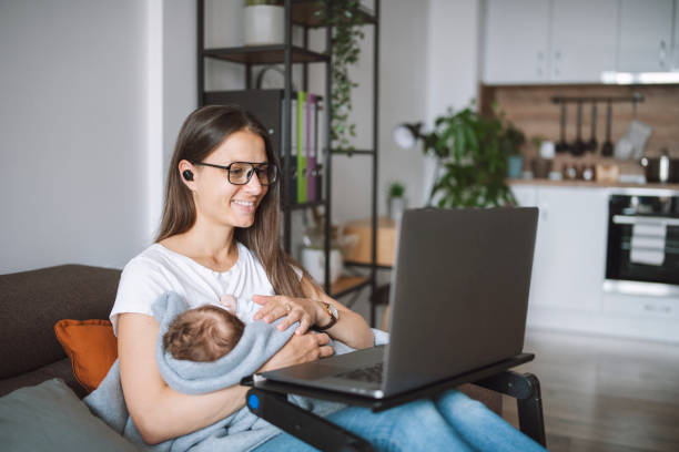 istock Young modern mother using technology while carrying her baby at home. 1307942882