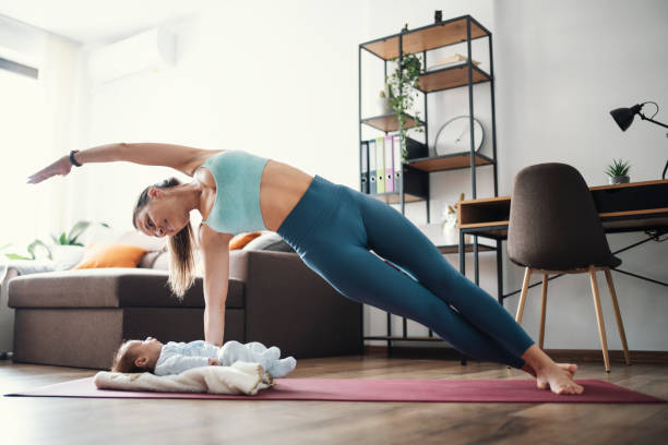 istock Mom and baby exercise together. 1307942887