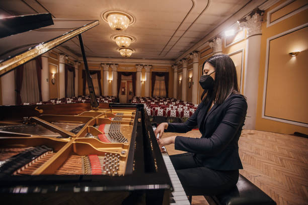 istock Female playing piano at concert hall 1307943541