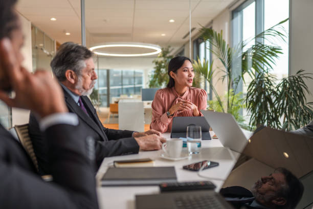istock Asian Female CEO Presenting Future Plans to Colleagues 1307943561
