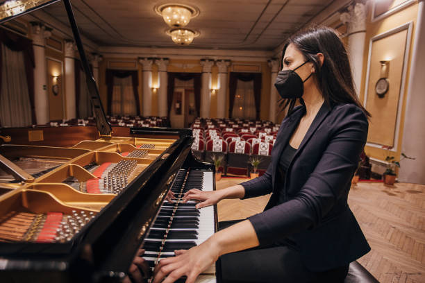 istock Female playing piano at concert hall 1307943573